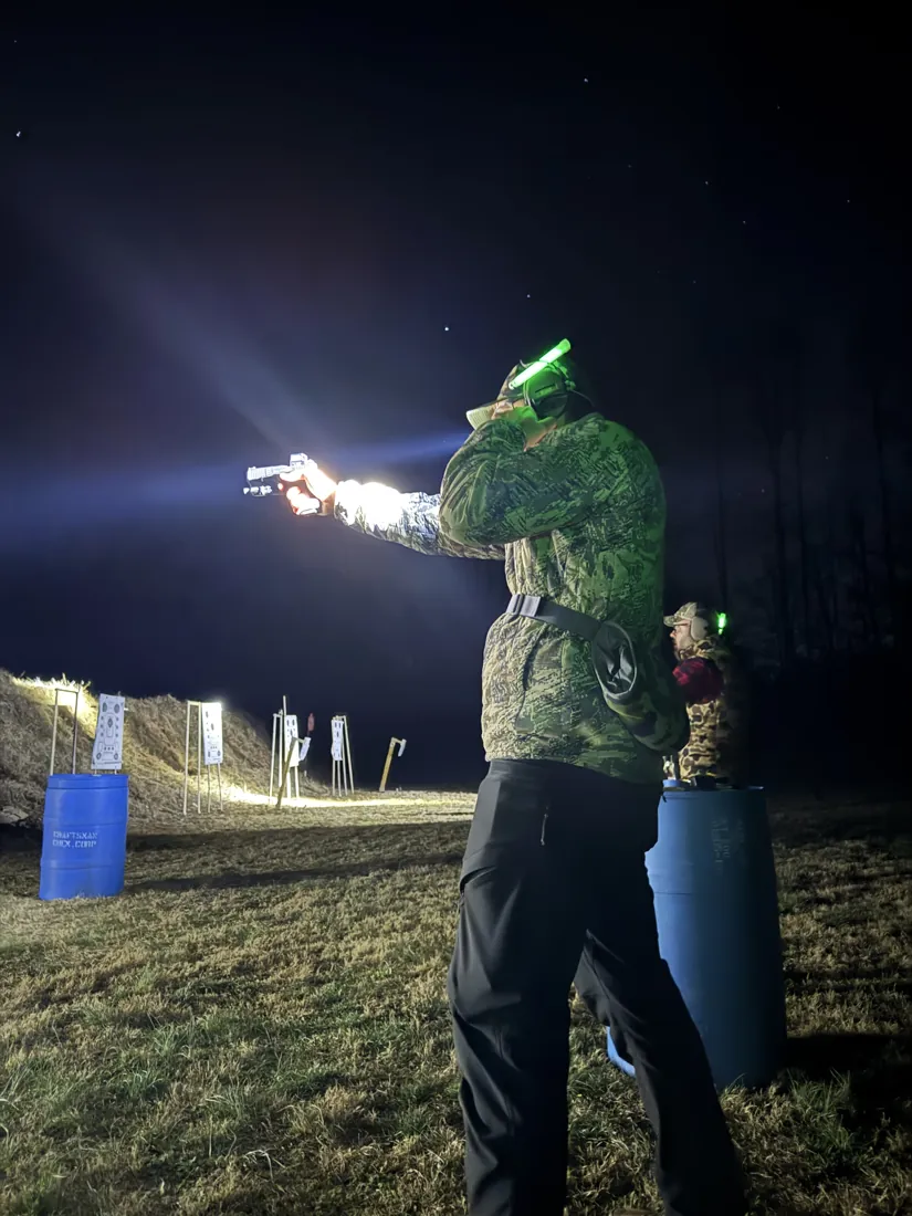 A shooter using a weapon-mounted light during low-light drills